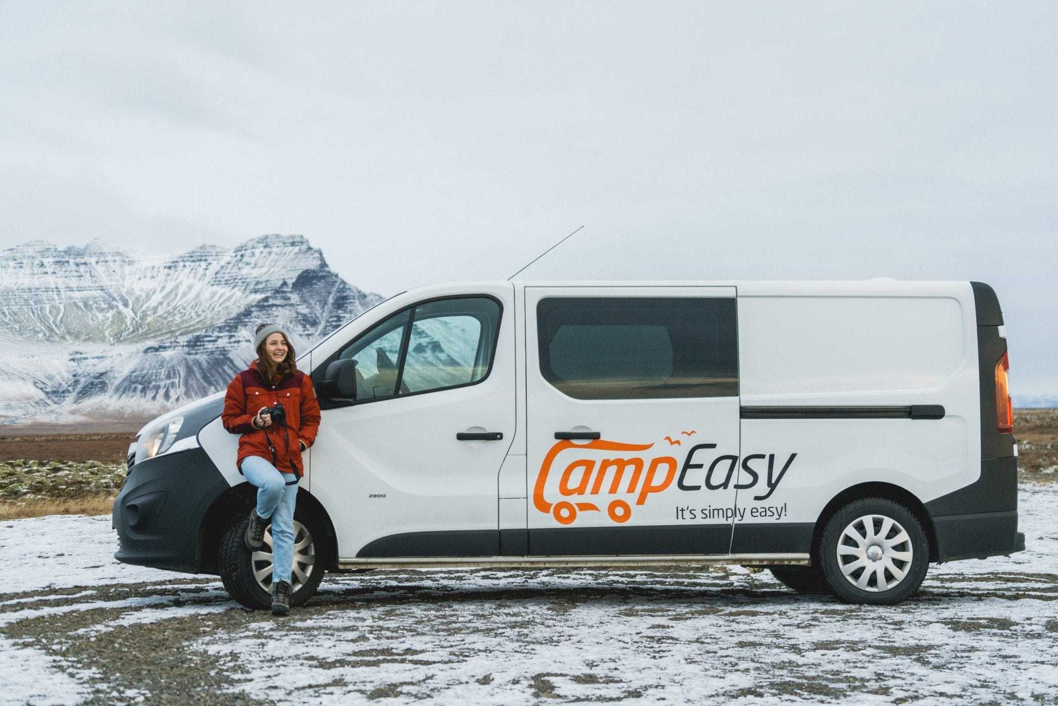 Woman standing in front of camper in Iceland
