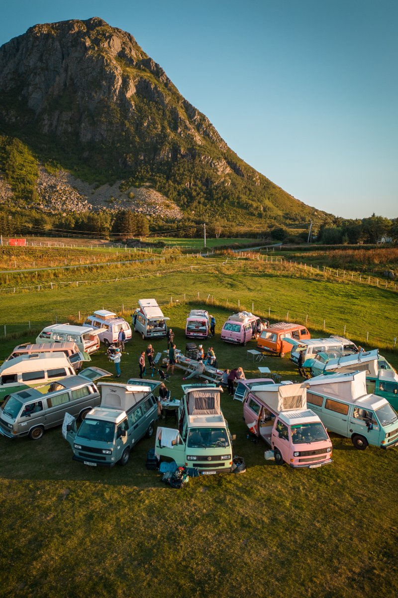 A woman is sitting in the back of the campervan