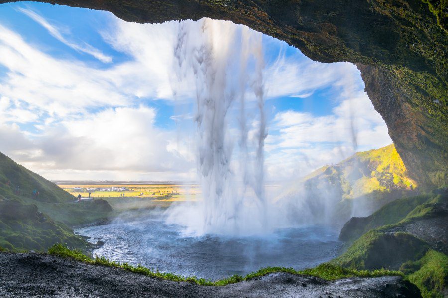 View from behind the water curtain of Seljalandsfoss waterfall.