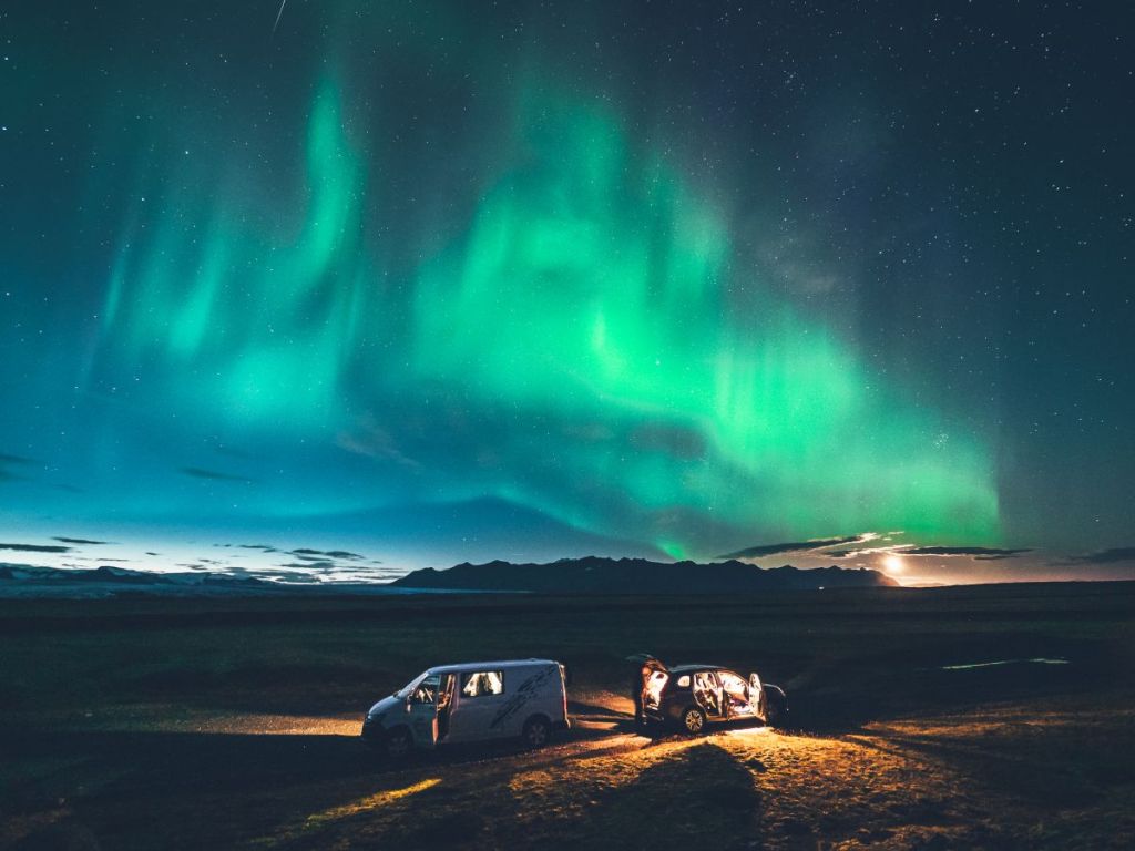 cars under northern lights