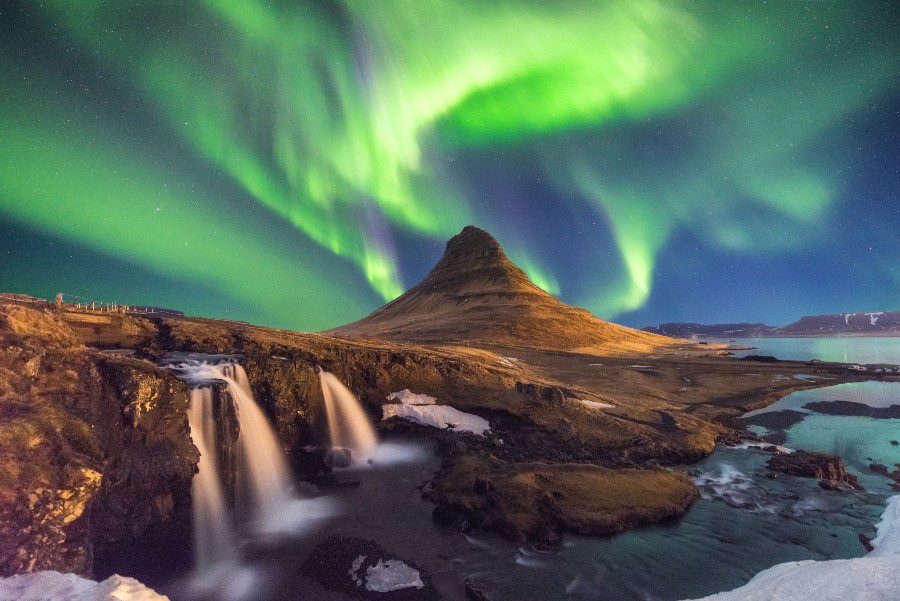 Northern Lights dancing above Kirkjufell mountain in Iceland.