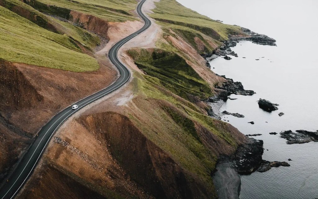 Road in Iceland on the edge of colorful mountain