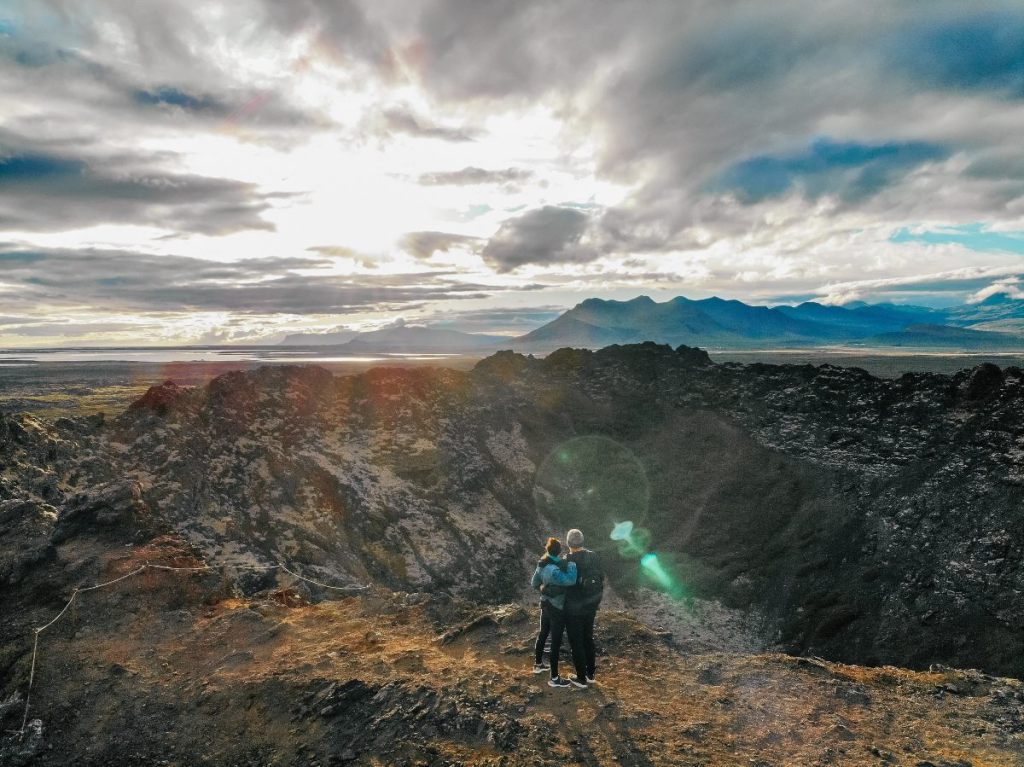 couple looking over a crater