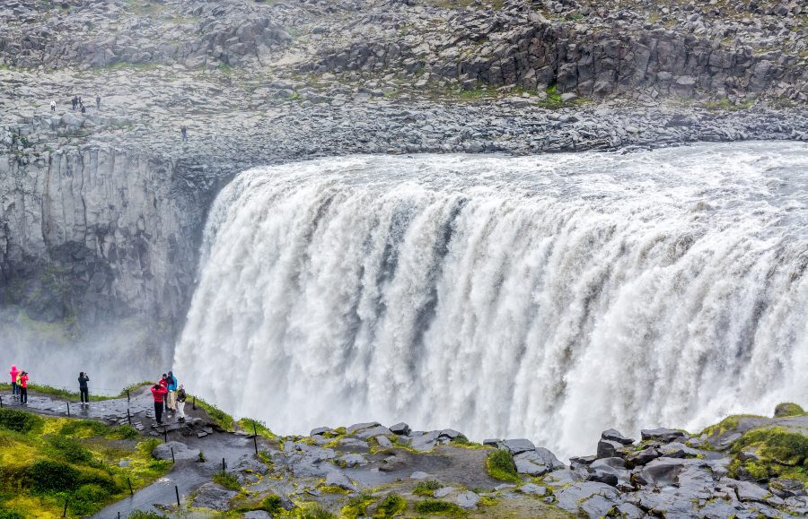 People watching the Dettifoss waterfall in Iceland.