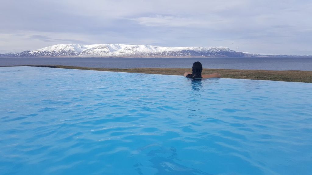 woman in a swimming pool outside travel iceland campervan