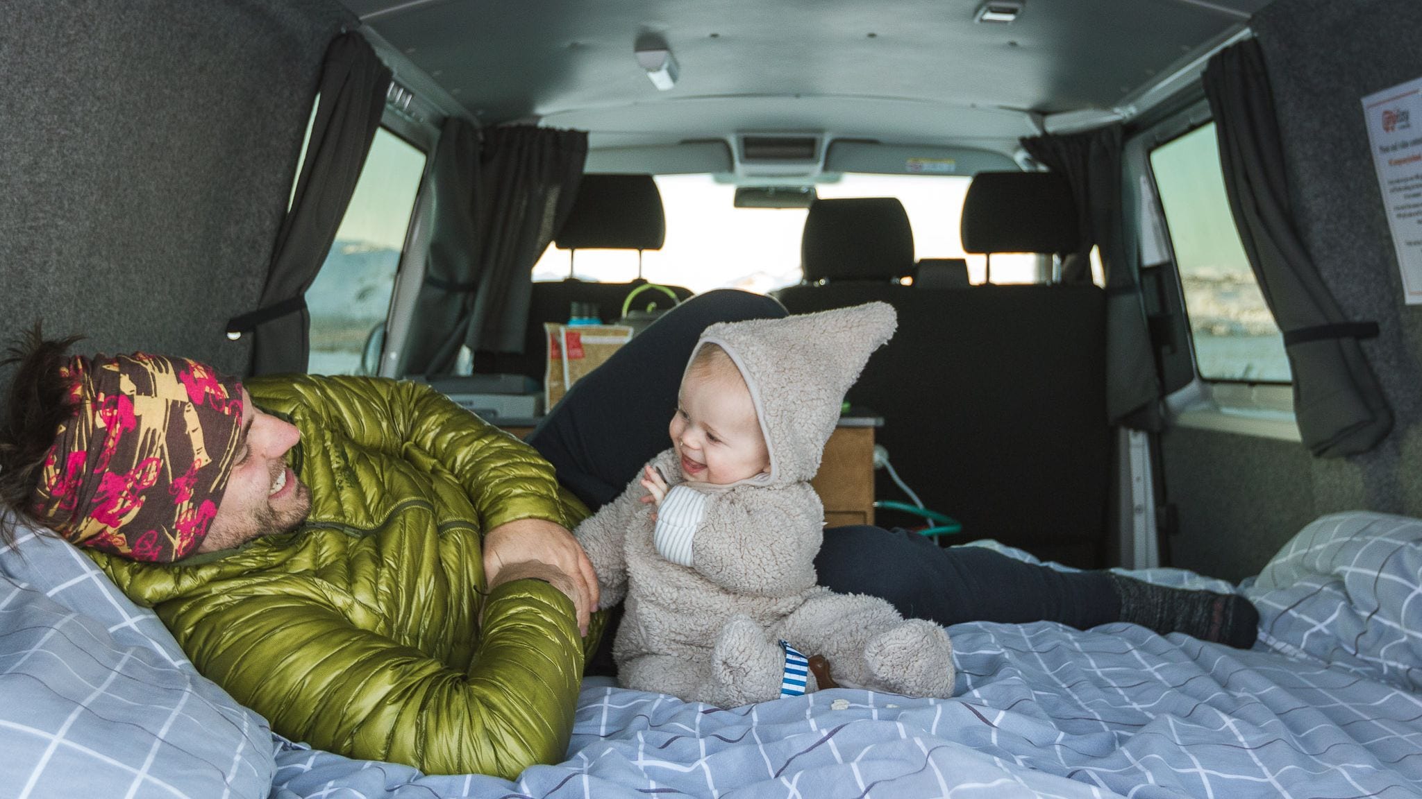man and child in camper camping in iceland