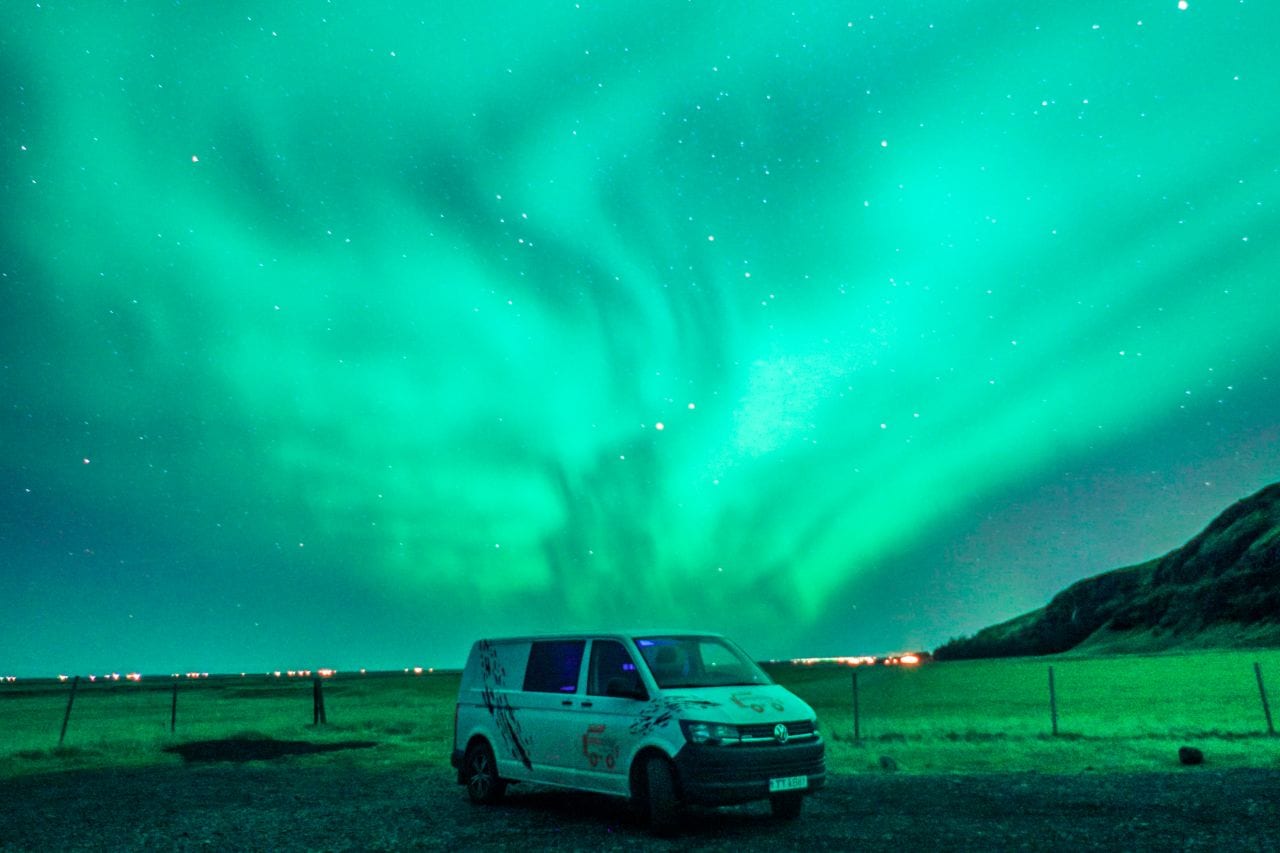 camper van under northern lights