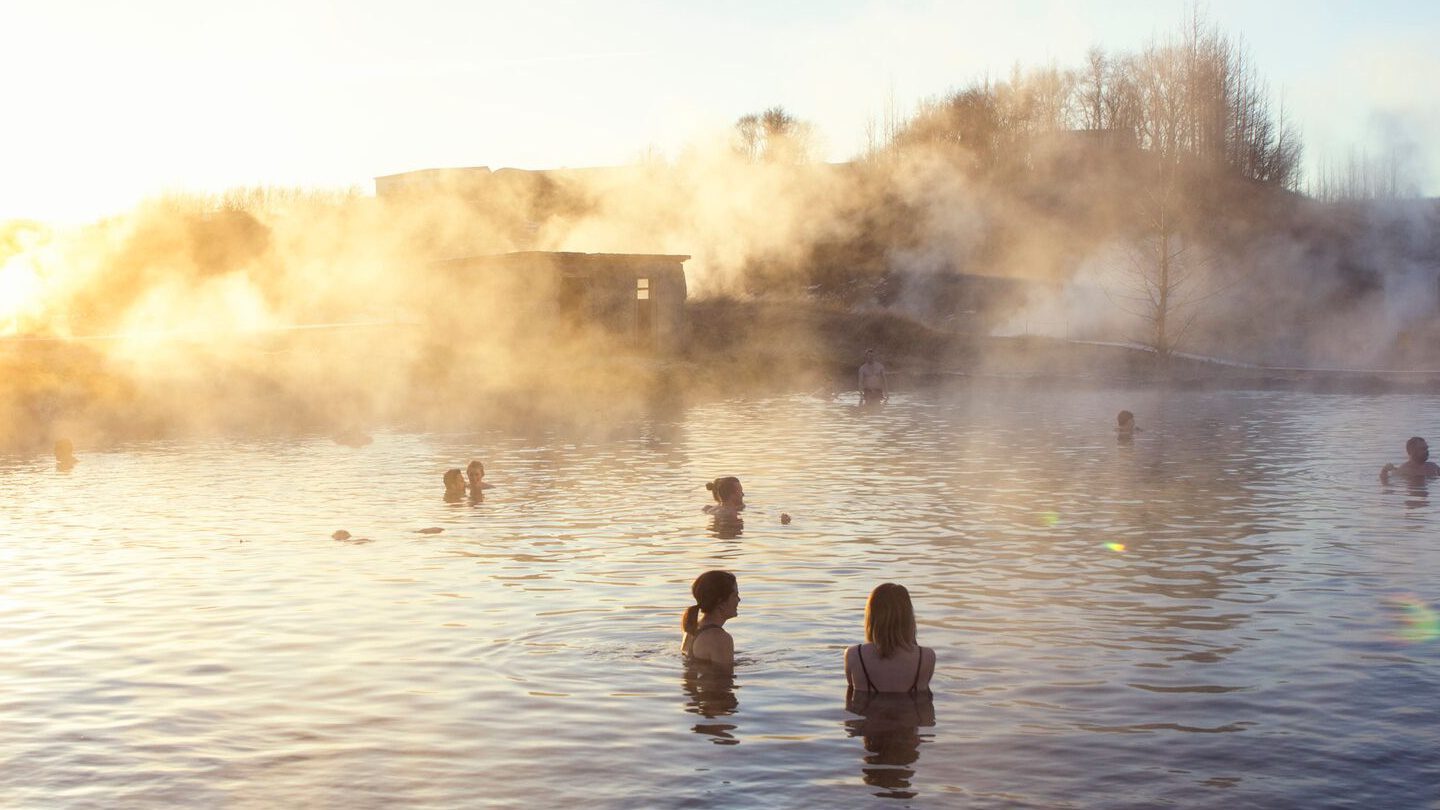 People relaxing in a hot natural swimming pool