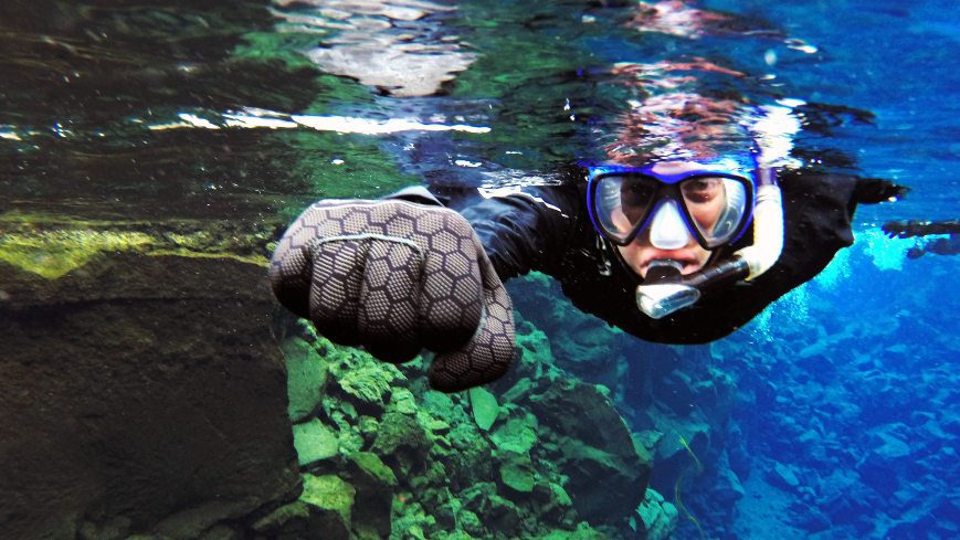 man snorkeling in a clear water