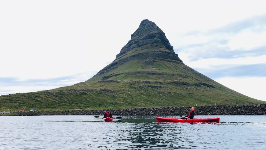 2 people kayaking with Kirkjufell in the background