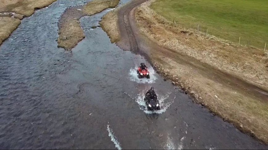 People riding on the river by ATV