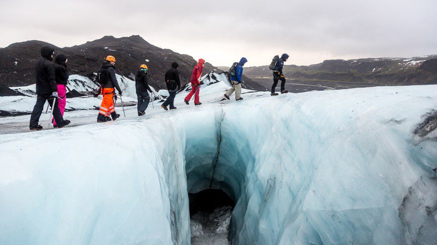 8 people walking on the glacier ice cap