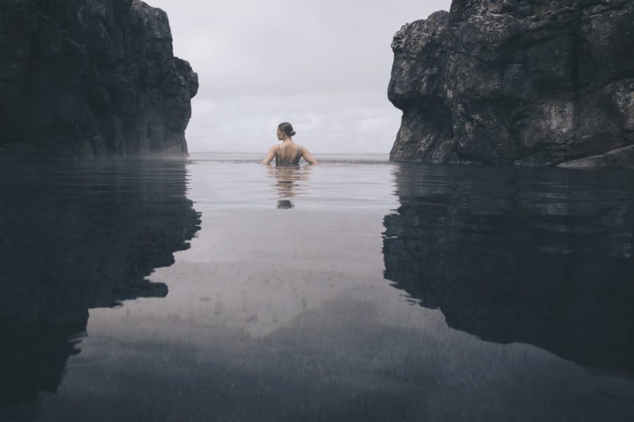 Girl between rocks in the 'natural hot spring in Iceland'