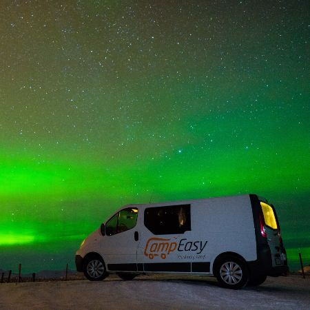 A big vehicle with northern lights in the background