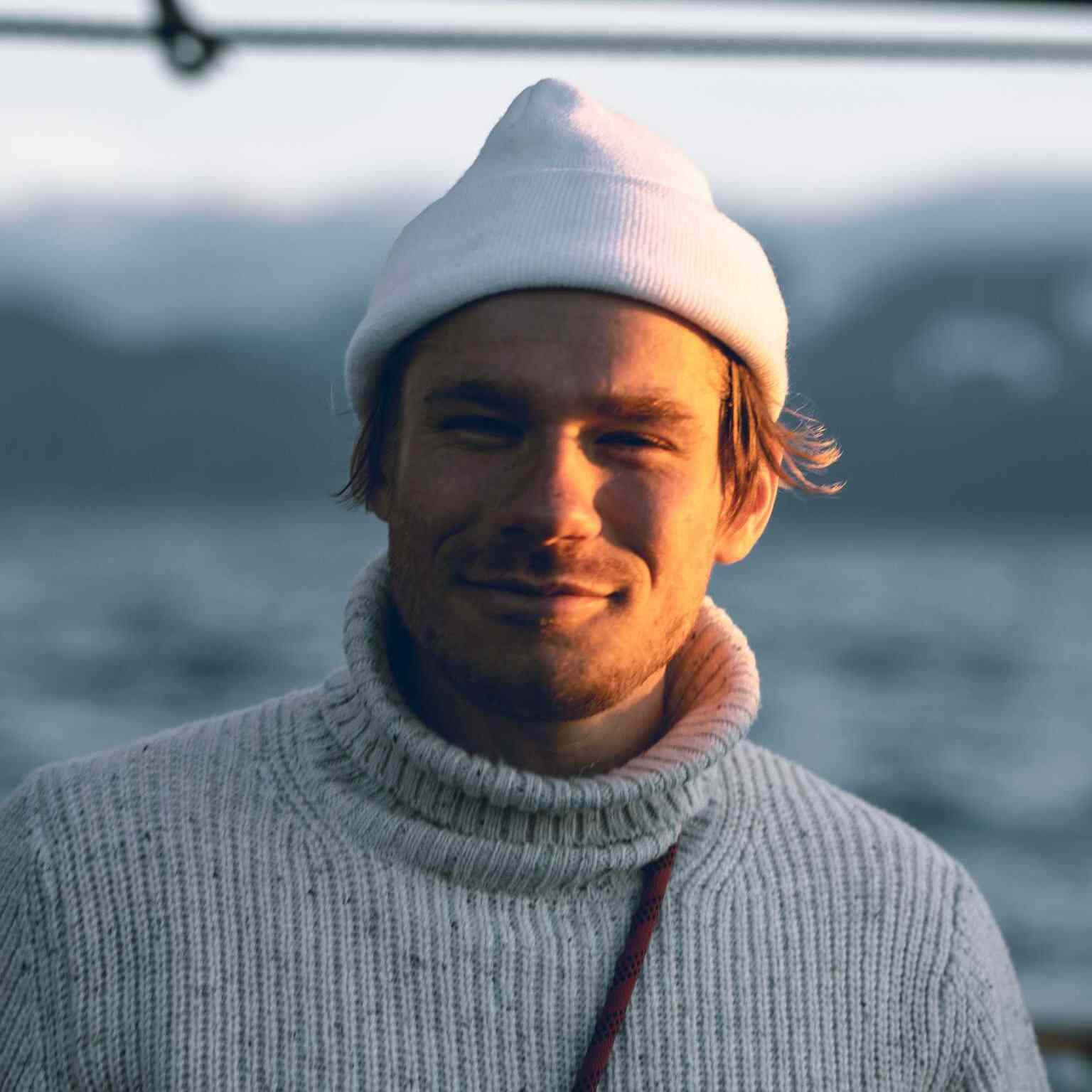 A man who is wearing an Icelandic sweater and hat