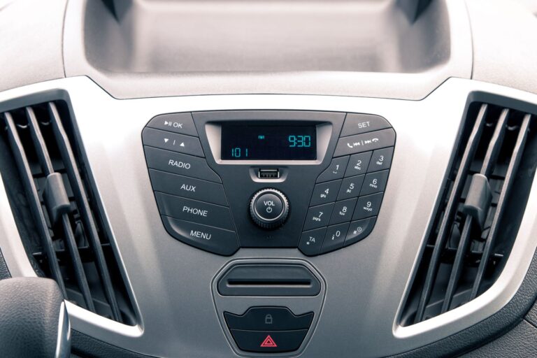 A close-up of a camping van dashboard featuring a radio and various control buttons.