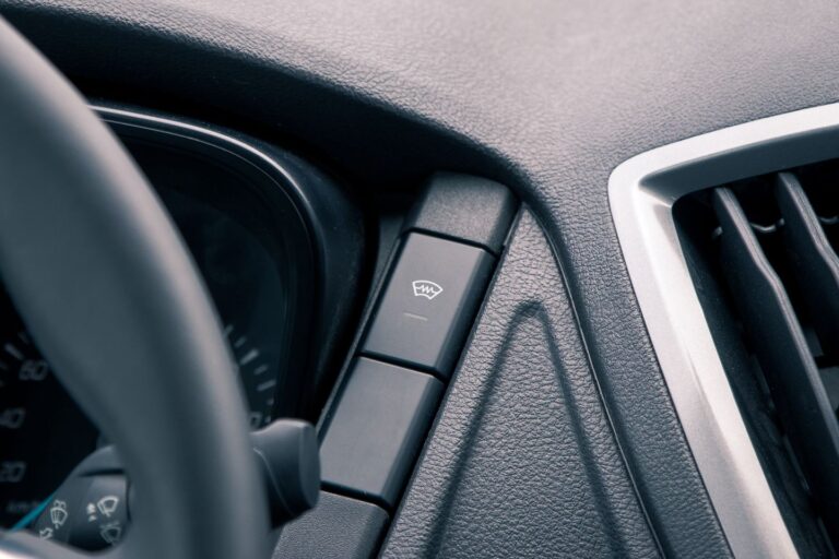 Close-up of a car dashboard button.