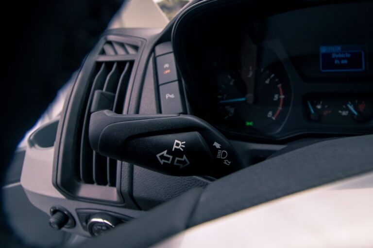 Dashboard view of a camping van featuring the steering wheel and various control buttons.
