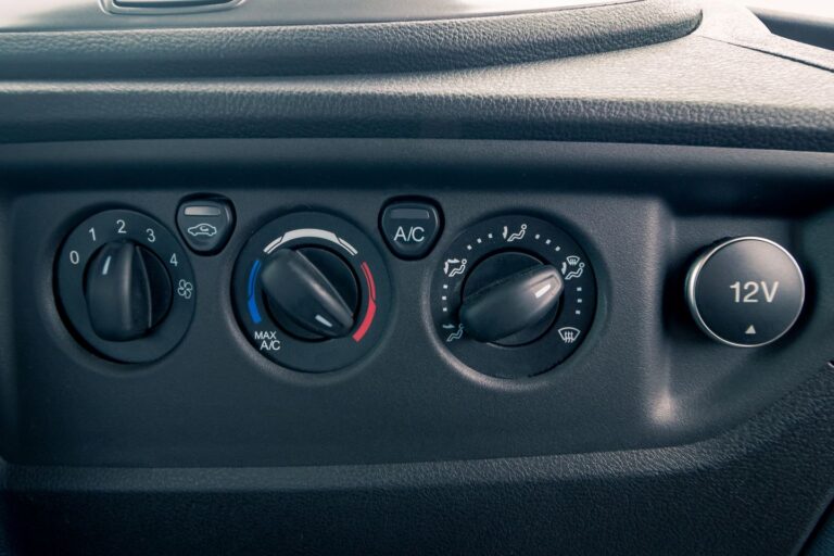 Air conditioning controls inside a camping van, featuring buttons and dials for temperature and fan speed adjustments.