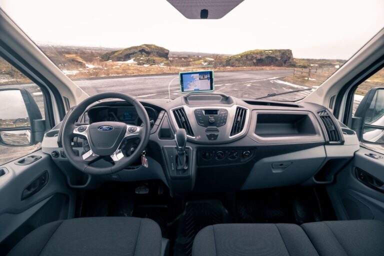 Interior view of a camping van showcasing the dashboard with controls and displays.