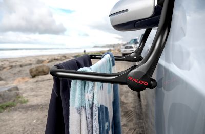 Laundry rack set on the car mirror with clothes on it