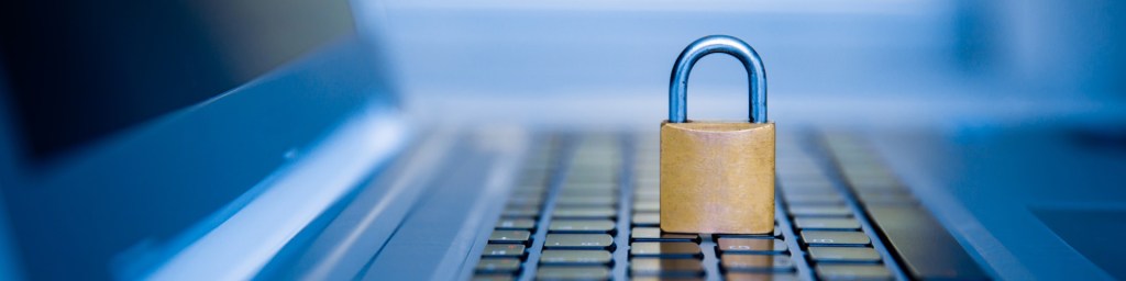 A padlock placed on a laptop keyboard, symbolizing data security and protection of privacy.