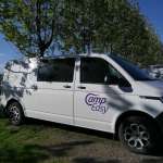 White CampEasy campervan parked under the shade of trees in a lush green park, ideal for a relaxing outdoor getaway in Iceland.