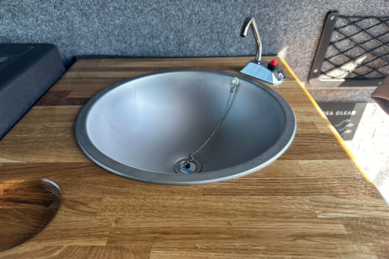 The sink located in the kitchenette inside the campervan.