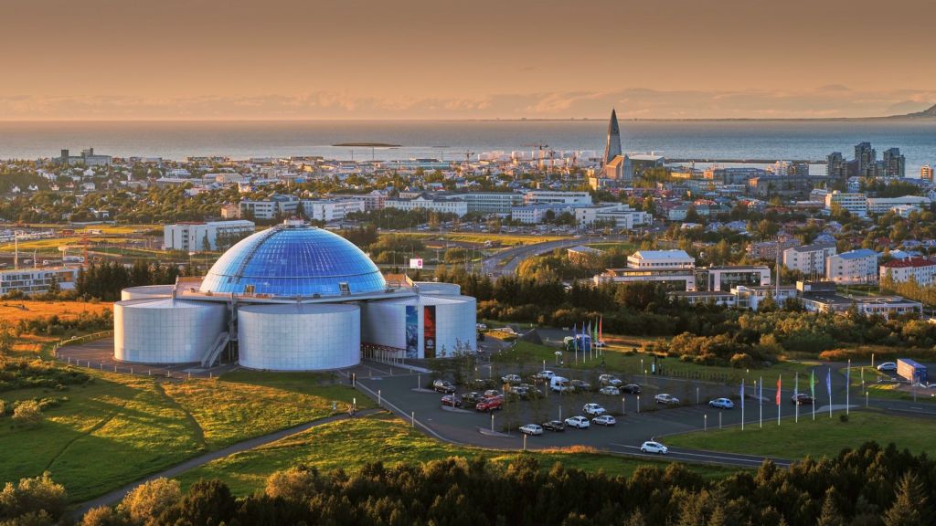 View of Perlan Museum in Reykjavik, Iceland, with its iconic glass dome and surrounding cityscape.