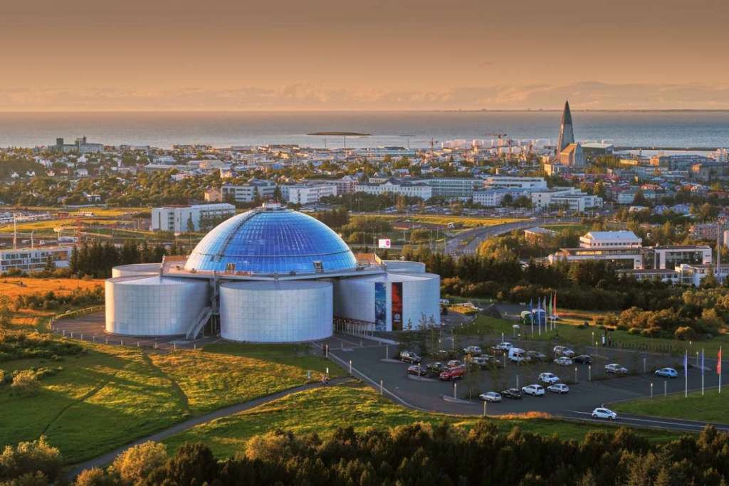 View of Perlan Museum in Reykjavik, Iceland, with its iconic glass dome and surrounding cityscape.