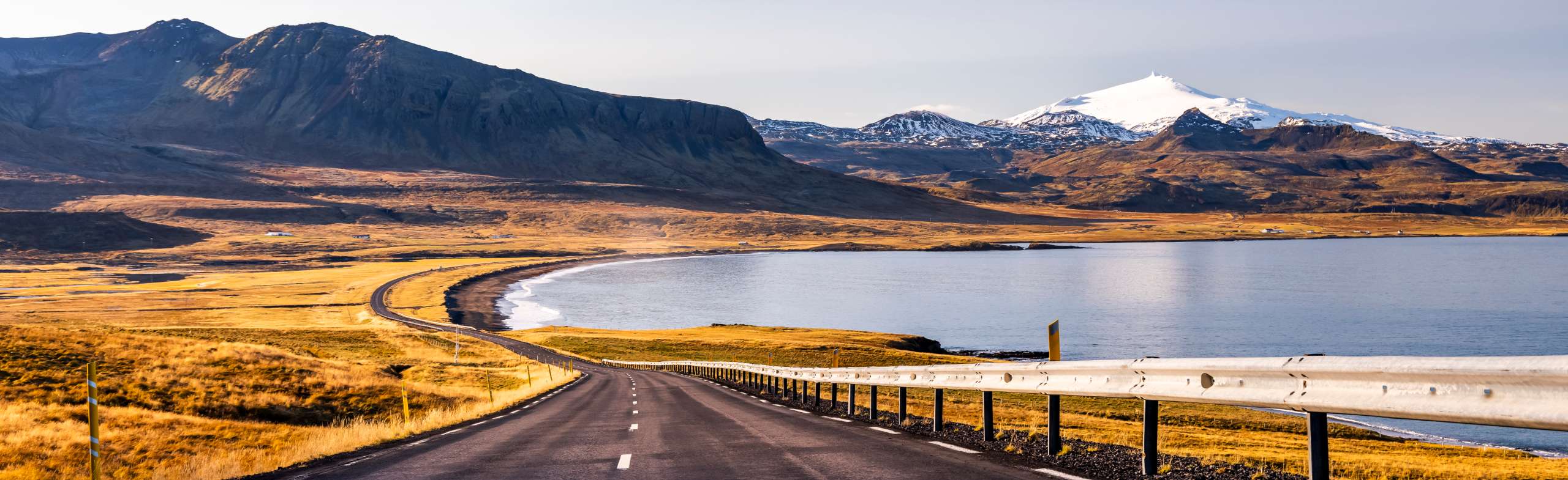 Scenic view of a winding road, surrounded by lush landscapes during a trip in Iceland.