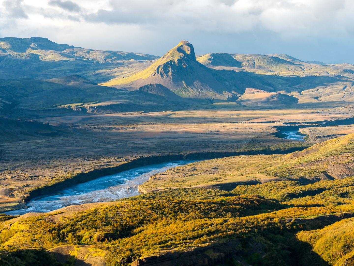 Beautiful sunset in the lush valley of Þórsmörk (Thorsmork) in Iceland’s southern highlands — a dramatic landscape of moss-covered mountains, glacial rivers