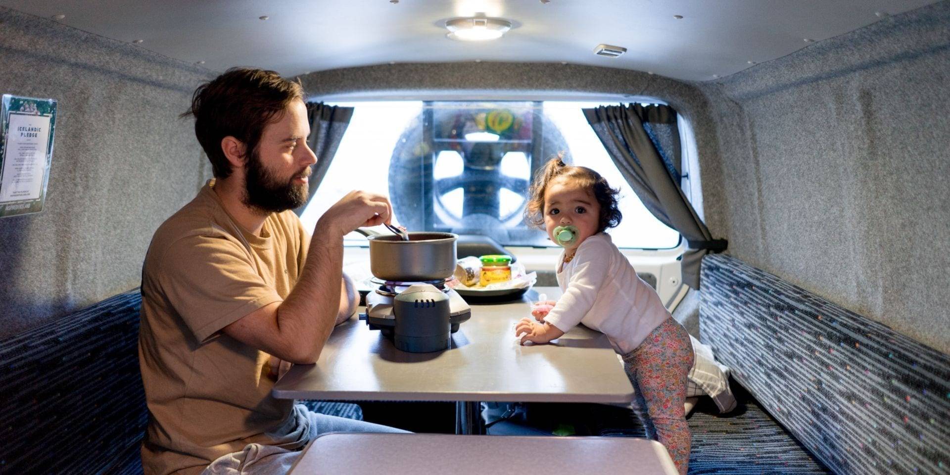 father and child in a camper